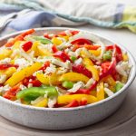 Colorful bell pepper salad with onions and feta.