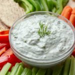 Greek tzatziki cucumber yogurt sauce with cut veggies.