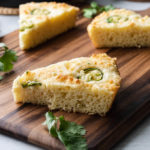 Slice of keto cornbread with jalapenos on a cutting board