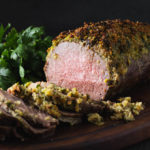 Sliced eye round roast beef with herb crust