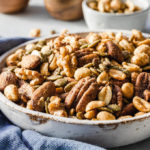 Savory keto nuts snack mix in serving bowl with blue naptin
